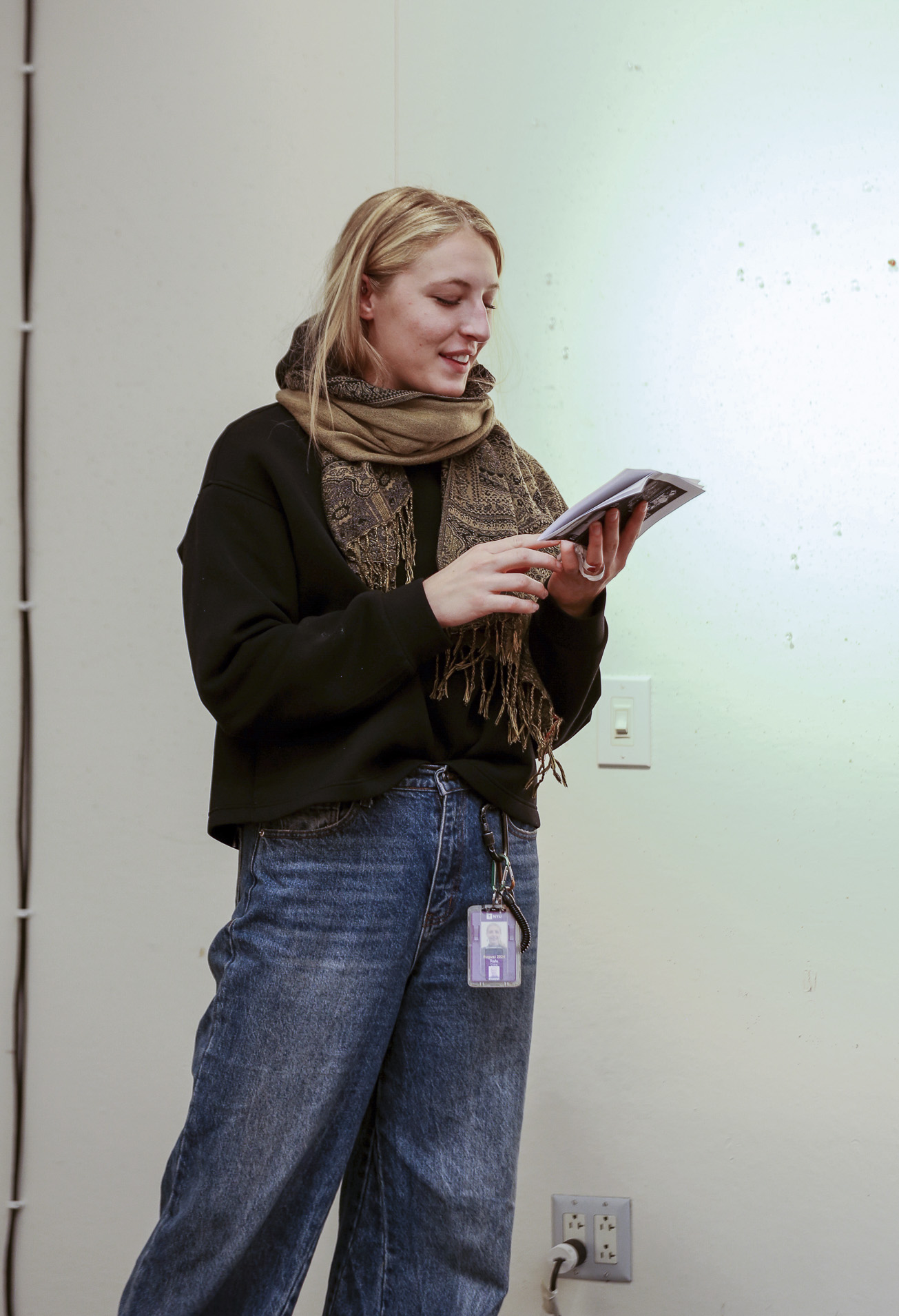 Student Cora Rafe holds an object while standing